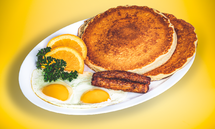 Breakfast plate with eggs, pancakes, and bacon